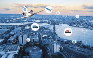Digital transportation and logistics network over a modern coastal city skyline, featuring an airplane, cargo ship, and delivery truck connected through smart technology icons and global supply chain graphics.